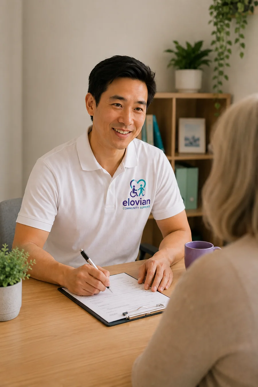 An Elovian Community Supports worker completing an intake form with a participant