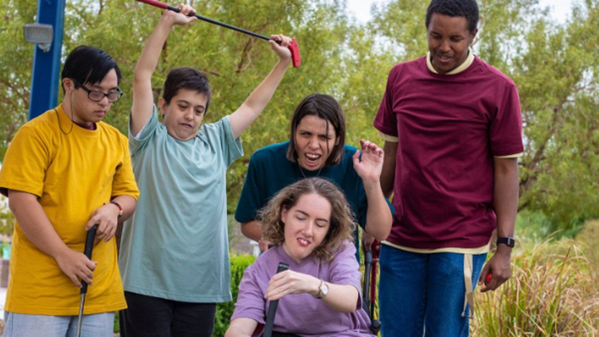 A group of friends taking part in a community activity together outdoors